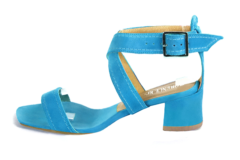 Turquoise blue women's fully open sandals, with crossed straps. Square toe. Low flare heels. Profile view - Florence KOOIJMAN